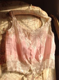 very, very beautiful pink silk and lace antique camisole 1880ssize  M/Lsoft silk fabric with delicate lace and pink silk ribbonsAlong the neck line the ribbon is a bit to short to wear in a larger size.I also saw a slightly underarm discolorationno weak era'sin excellent conditionbust  40"  or smaller  102 cm or smallerwaist  32" or smaller   82 cmlength  18"   46 cm Feminine Pink Lace Top With Lace Patchwork, Feminine Pink Lace Top With Patchwork, Pink Fitted Lace Top Camisole, Fitted Pink Camisole With Lace Top, Fitted Lace Top Pink Camisole, Pink Lace Tops With Spaghetti Straps, Pink Lace Top With Spaghetti Straps, Pink Lace Top With Lace Patchwork, Fitted Pink Lace Top With Lace Trim