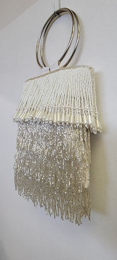 A beautiful ring handle bag. al hand made. size 7x7 inch. in combination of ivory and silver fringe. ivory fringe with drop pearl beads satin lining. also available in black and pewter. Elegant Fringe Bags For Wedding, Elegant Fringe Clutch For Formal Occasions, Elegant Fringe Clutch For Formal Events, Elegant Fringed Bags For Wedding, Elegant Fringe Evening Bag, Elegant Wedding Bags With Fringe, Elegant White Bags With Tassels, Elegant Fringe Clutch Evening Bag, Elegant Fringed Clutch Evening Bag