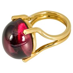 "Costis" Stone on Wire Ring with an Oval Cabochon 37.74 carats Pink Tourmaline, on 18K Yellow Gold. A really special gemstone, which makes this ring one-of-a-kind. Our most minimal and elegant way to emphasize a gem's beauty mounted on wire. A perfect example of "the simplest designs, are the hardest to achieve". An important characteristic of Costis Jewelry: the amazing gemstones! Diamonds may be the protagonists in the jewelry industry, but nothing can surpass the intrigue, variety and endless combination possibilities that the colored stones offer. This is the reason that Costis’ collections are full of color and of so many interesting and different combinations. The splendor of stones and cuts define Costis' jewelry, exploring diamonds, pearls, rubies, sapphires, emeralds, but also his Wire Ring, Wire Rings, Ring Oval, Oval Cabochon, Pink Tourmaline, Cocktail Rings, Semiprecious Stones, Precious Stones, Stone Color