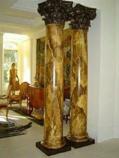 two large marble pillars in the middle of a living room