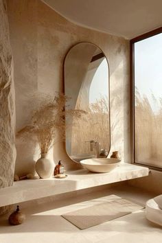 a bathroom with a large window, sink and mirror