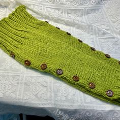 This is a for a pair of long spats / boot cuffs. These were knit out of 100% acrylic avocado green yarn. These measure 21 inches with 7 working wooden buttons on each spat. The buttons have been sewn on using a yellow flower embroidery design. The top cuffs and bottom cuffs can be folded over for a different style. Care: Machine wash and dry Bonnie G Morrow comes from a family of artists and earned her living through her art. Her art is in collections around the world. She works in oil, acrylics, cold wax, encaustics, mixed media, glass, fiber arts and whatever grabs her interest at the time. Her works can be seen under Ambrosia Arts, Bonnie G Morrow, BG Morrow and BGM. Bonnie only uses the highest grade artist materials in her works. Thank you for viewing my work. Casual Green Leg Warmers For Fall, One Size Green Leg Warmers For Winter, Green One Size Leg Warmers For Winter, Fitted Green Leg Warmers For Fall, Green Yarn, Artist Materials, Handmade Knit, Winter Gloves, Boot Cuffs