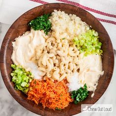 a wooden bowl filled with different types of food