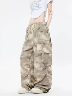 Embrace the street aesthetic with our Faded Baggy Camo Cargo Pants, perfect for making a statement while on the move.
Designed with a natural waist, these cargo pants offer a blend of comfort and durability. The camouflage pattern adds an edgy touch, while the drawstring and convenient pockets provide functionality and ease. The relaxed wide-leg silhouette ensures a nonchalant yet purposeful style, tailored for the contemporary wardrobe.
Pair them with a cropped hoodie and sneakers for running e Urban Baggy Parachute Pants With Hip Pockets, Summer Cargo Pants With Hip Pockets For Streetwear, Hip Hop Bottoms With Cargo Pockets For Outdoor, Summer Streetwear Khaki Cargo Pants, Summer Khaki Cargo Pants For Streetwear, Baggy Y2k Wide Leg Pants With Pockets, Y2k Style Baggy Wide Leg Pants With Pockets, Summer Streetwear Cargo Pants With Cargo Pockets, Urban Baggy Cargo Parachute Pants