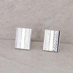 This men's silver tone costume cufflinks are in the shape of rectangles but have a textured pattern on the polished frame. The rectangles measures 18.3mm in height and 13.7mm in length. Together, they weigh 10.13 grams. They each have "Swank" engraved on the back. Condition: Pre-Owned *All items are thoroughly inspected for quality assurance purposes Party Suits, Tie Clips, Argentium Silver, Tie Accessories, Suit And Tie, Cuff Links, Silver Man, Wedding Classic, Quality Assurance