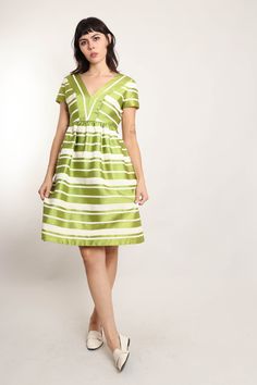 FEATURES - 1960s dress - Green, white colors - Formal evening wear - Mod vibes - Striped print - Satin fabric - Empire waistline - Knee length - Zips up the back CONDITION Great vintage condition: extremely faint discoloration on a few of the cream striped panels that are only noticeable under meticulous inspection, few pea sized lightened areas near a waterline on one of the panels. MEASUREMENTS & FIT suggested letter size: L shoulder: 16.25" bust (underarm): 38" waist: 31"-32" max hip: 46" len Striped V-neck Party Dress, Green Empire Waist Evening Dresses, Striped Midi Dress For Evening, Striped A-line Lined Dress, Green Empire Waist Dress For Formal Events, Green Empire Waist Dress For Formal Occasion, Retro Green Evening Dress, Green Retro Evening Dress, Green Retro Cocktail Dress