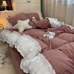 an unmade bed with ruffled sheets and pillows