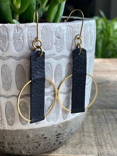 "Leather and Brass Camel Earrings Leather earrings are perfect for every outfit and any occasion from dressy to casual. So lightweight and comfortable you will forget you have them on! ITEM DETAILS - Length: 2.75\" (Including ear wire) - Width: Approx. 1.25\" - Material: Black leather and raw brass hoop. - Hardware: Raw Brass Ear Wire (Nickel and Lead Free for sensitive ears). PLEASE NOTE Raw brass is a metal alloy of copper and zinc that is NICKEL FREE. It will develop a subtle patina over time giving it the piece a more vintage look. This oxidation can be removed with a soft polishing cloth is desired.  All purchases from Orange and Prairie arrive in a linen gift bag Find more earrings here: https://www.etsy.com/shop/orangeandprairie?ref=seller-platform-mcnav&section_id=18562705 Find my Black Leather Earrings, Bead And Leather Earrings, Leather And Metal Earrings, Leather Earring Ideas, Wire Earrings Diy, Boho Leather Jewelry, Black Leather Jewelry, Leather Jewelry Making, Handmade Leather Jewelry