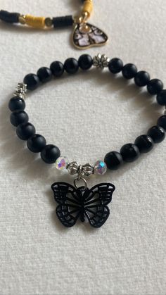 Introducing the ultimate accessory for all you dark and daring fashionistas out there - our black butterfly bead bracelet! With its goth-inspired, this piece is the perfect addition to any Halloween outfit or just an edgy everyday look.  Featuring intricate flower spacer beads and a breathtaking black butterfly charm, this beaded bracelet is sure to turn heads wherever you go.  Measuring 7 inches in width, it's the perfect fit for most wrists. So why wait? Add a touch of dark elegance to your wardrobe today with this new, edgy bracelet. Edgy Black Bracelet For Halloween, Edgy Black Halloween Bracelet, Black Edgy Bracelets As Gift, Black Punk Bracelet For Halloween, Edgy Black Jewelry For Festivals, Gothic Black Adjustable Beaded Bracelets, Gothic Adjustable Black Beaded Bracelets, Gothic Black Beaded Adjustable Bracelet, Black Adjustable Alternative Style Bracelets