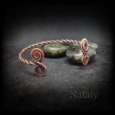 This listing is for wire wrapped twisted bangle cuff bracelet with little spirals that is made of hammered copper. Looking for rustic jewelry piece for gift or to spoil yourself? This adjustable bracelet is the perfect choice. It as 100% handmade and made with love. Order this stylish hammered copper bracelet right now!  SIZE AND MATERIALS *The bangle bracelet is adjustable and fits any size. * Materials: copper  HOW IT WAS MADE This twisted bracelet is handcrafted in wire wrapping technique with copper metal. The wire was hand sculptured and forged for shape and strength. Then oxidized and hand polished to highlight the texture. Patina gives it a vintage viking or celtic style look.   MEANINGS * You may wish to embrace your the 7th or 21st wedding anniversary with a traditional gift made Handmade Adjustable Spiral Cuff Bracelet, Spiral Metal Cuff Bracelet As Gift, Adjustable Spiral Copper Bracelets, Adjustable Spiral Wire Wrapped Bracelets, Handmade Spiral Copper Bracelets, Adjustable Spiral Copper Bracelet, Adjustable Copper Spiral Bracelet, Handmade Spiral Metal Bracelet, Handmade Spiral Copper Bracelet