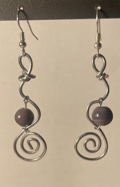 handmade silver spiral, purple beaded dangle drop earrings. Funky Silver Earrings, Handmade Silver Swirl Earrings, Silver Swirl Wire Wrapped Earrings, Nickel-free Purple Sterling Silver Beaded Earrings, Elegant Silver Beaded Earrings Wire Wrapped, Elegant Silver Beaded Earrings With Wire Wrapping, Spiral Beaded Silver Jewelry, Wire Wrapped Purple Round Bead Earrings, Silver Spiral Beaded Jewelry