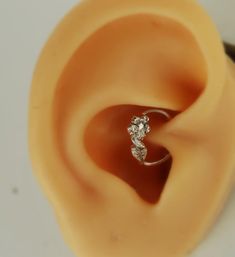 an ear with a single diamond ring on it