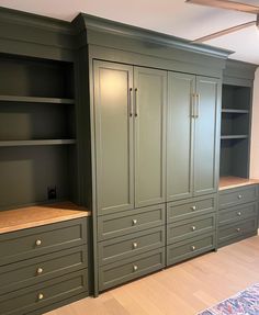 an empty room with green cabinets and drawers