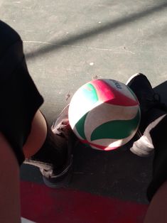 a person standing next to a ball on the ground