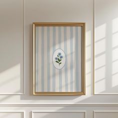 a painting hanging on the wall above a fireplace in a room with white walls and blue stripes