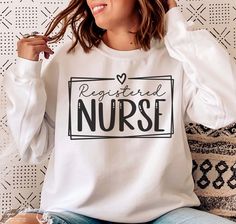 a woman sitting on a couch wearing a white shirt with the words register nurse printed on it