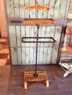 an old fashioned wooden stand with clothes on it