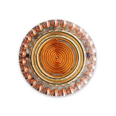 an orange and gold beaded object on a white background