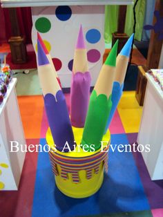 there are many colorful crayons in a bucket on the floor at this event