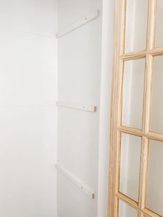 an empty room with white walls and wood trimmings on the wall, next to a closed window