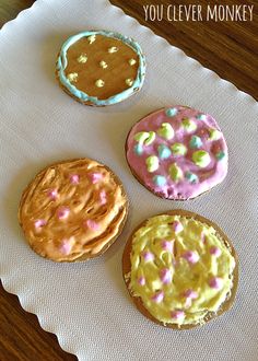 three decorated cookies sitting on top of a paper towel