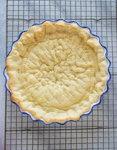 an uncooked pie crust on a cooling rack