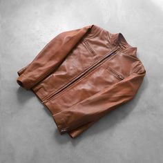 This brown leather biker jacket, with its sleek, polished appearance, is made of premium-quality sheepskin leather. It is designed to lift your overall style game. This timeless vintage biker jacket blends classic biker style with contemporary fashion, ensuring durability and a luxurious feel. This elegant biker-style jacket can easily be worn on casual and semi-formal occasions. This tailored-fit brown leather jacket has a sleek, fitted silhouette with stitched seams. Four external zipper pocke Brown Moto Biker Jacket For Streetwear, Classic Vintage Brown Leather Biker Jacket, Brown Biker Leather Jacket For Streetwear, Brown Cafe Racer Biker Jacket For Biker Events, Cafe Racer Leather Outerwear For Biker Events, Brown Moto Outerwear For Streetwear, Classic Brown Biker Jacket For Streetwear, Classic Brown Leather Jacket For Motorcycling, Vintage Brown Biker Jacket For Winter