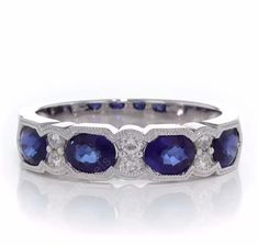 a white gold ring with blue sapphires and diamonds