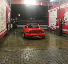 a red car is parked in the garage