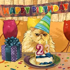 a cat wearing a birthday hat sitting in front of a cake with the number two on it