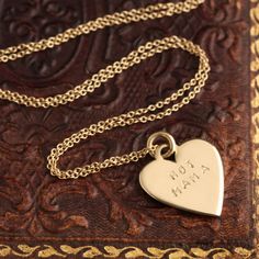 ((about)) I want to share a necklace I made for me AND for you: It's a tiny 14k gold blank heart we can stamp with a message, a name, a date - whatever you like. Use up to 12 characters, not including spaces. And once we stamp it, you own it—we don't allow exchanges or refunds on customized pieces like these. Indicate your message in the "notes" field at checkout. ((details)) Made by hand in our Brooklyn studio. Materials: 14k gold. Measurements: Chain measures 16". ((inspiration))In July, I had Hand Stamped Sterling Silver Necklaces In Yellow Gold, Engraved Yellow Gold Heart Necklace For Everyday, Yellow Gold Engraved Heart Necklace For Everyday, Yellow Gold Engraved Heart Necklace, Hand Stamped Yellow Gold Necklace For Anniversary, Mother's Day Hand Stamped 14k Gold Necklace, 14k Gold Hand-stamped Charm Necklace For Anniversary, Hand Stamped Yellow Gold Anniversary Necklace, Stamped 14k Gold Necklace For Anniversary