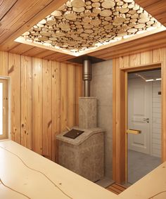 a room with wood paneling and a stove in the corner next to a counter