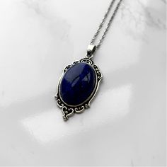 Lapis Lazuli Pendant Necklace | Antique Silver or Gold | 24" Chain Higher Knowledge + Third Eye + Psychic Abilities + Transformation Carry your intentions wherever you go with a handmade Lapis Lazuli pendant necklace. Each pendant is custom made with an antique gold or silver filigree base and comes with an 24" chain with lobster clasp fastening. Known as the "Wisdom Stone" and said to contain the soul of the gods, Lapis Lazuli has been favored by royals, artists, and magical practitioners throu Luxury Faceted Lapis Lazuli Necklaces, Handmade Oval Lapis Lazuli Necklace, Vintage Lapis Lazuli Jewelry As A Gift, Vintage Lapis Lazuli Jewelry As Gift, Oval Pendant Lapis Lazuli Jewelry Gift, Vintage Lapis Lazuli Jewelry For Gifts, Lapis Lazuli Round Pendant Necklace Gift, Lapis Lazuli Pendant Necklace For Gift, Nickel Free Lapis Lazuli Necklace For Gift