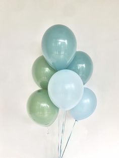 a bunch of blue and green balloons in a vase