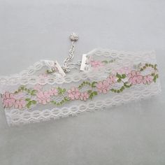 "Vintage white netted lace with a lovely pink flower and green leaf pattern makes up this choker style necklace.   The lace is crimped in silver bars and there is a matching silver extension chain for adjustable sizing between 13\" and 15 \" neck measurement.  There is a wire wrapped silver bead dangle on the chain and a hook closure for adjustable sizing.  The width of the lace is 1 3/4\". All of my jewelry items come boxed and ribbon tied and tagged for easy gifting." Elegant White Flower Choker, Feminine White Choker Jewelry, Vintage White Summer Jewelry, White Vintage Summer Jewelry, Spring Gift Choker, Pink Necklaces For Spring Wedding, Spring Silver Choker Jewelry, Feminine White Necklace For Spring, White Flower Choker For Spring