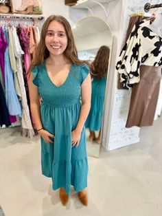 You have just found THE PERFECT dress for Fall with our Fall Dress to Impress Smocked Maxi Dress! With a V neckline, flutter mini sleeves, and a smocked bodice, this dress flatters every figure. The tiered midi skirt is lined and has a medium weight, making it perfect for any occasion. And don't forget - it has pockets! Trust us, this teal dress is not one to miss. Available in sizes small to 3X. The Deets: Fit: True to size Material: 100% Polyester Brand: Blu Pepper Measurements: 45" long, 13" Sundress With Smocked Back And Flutter Sleeves, Flutter Sleeve Sundress With Smocked Back, Casual Midi Dress With Smocked Bodice And Flutter Sleeves, Summer Midi Dress With Smocked Bodice And Ruffle Sleeves, Flutter Sleeve Midi Sundress With Smocked Back, Casual Midi Dress With Smocked Back And Ruffle Sleeve, Summer Dresses With Smocked Cuffs And Ruffle Sleeves, Vacation Midi Dress With Smocked Bodice And Flutter Sleeve, Flowy Knee-length Smocked Dress