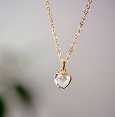 "Clear Crystal Quartz Heart Necklace - 14k Gold Filled Looking for a unique accessory to show off your self love, or love for that special someone? Crafted from 14k gold filled and natural clear quartz, this pedant is the perfect, sparkling way to show anyone your love.  Crystal Quartz, also called Rock Crystal, is considered the ultimate healing stone. It balances and revitalizes the mental, physical, spiritual, and emotional aspects of the body. Also, it's believed to amplify the energy or int Delicate Heart Cut Jewelry Gift, Delicate Heart Cut Jewelry For Gift, Dainty Heart Cut Jewelry For Valentine's Day, Minimalist Heart Shaped Diamond Cut Jewelry, Delicate Heart Cut Birthstone Jewelry, Minimalist Heart-shaped Diamond Cut Jewelry, Delicate Heart Cut Jewelry With Heart Charm, Delicate Heart Cut Jewelry With Heart Beads, Dainty Heart-shaped Jewelry For Anniversary Gift