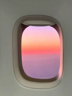 an airplane window looking out at the ocean