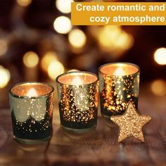 three lit candles sitting on top of a table next to a star shaped candle holder