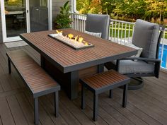 a table and chairs on a deck with a pool in the background