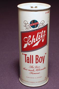 a can of tall boy sitting on top of a purple floor next to a wall