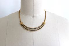 Vintage 18K Plated Curved Multi Row Necklace Multi Bar Necklace Vintage WJN Necklace Measures approximately 16" with a sturdy clasp. Beautiful 2 tone fixed bars with a serpentine chain. LIttle W.J.N. tag. Has a really nice weight and feel.  ★ Shop more vintage jewelry here:  https://www.etsy.com/shop/TheVintageMistress?section_id=8158835 ★ Visit the Shop: http://www.etsy.com/shop/TheVintageMistress?ref=si_shop Choker Necklaces, Necklace Vintage, Bar Necklace, Vintage Necklace, Halloween Shopping, The Row, Necklace Etsy, Really Cool Stuff, Choker Necklace