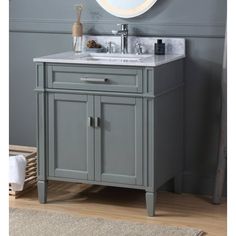 a bathroom vanity with a round mirror above it