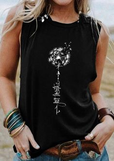 a woman wearing a black tank top with a dandelion on it