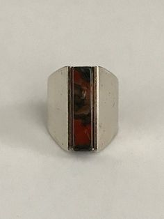 This ring unites quiet strength with sophisticated simplicity. A rectangular agate column, just short of 1" in length and 1/4" wide, makes up the center of this eye catching ring. It's held in by the silver frame which starts out the same length as the stone and tapers off in the back and turns into a comfortable band. It is signed inside the band. The Henning Ulrichsen jewelry company was established in Denmark in 1951 and is still in existence and being run by the second generation. This ring Modernist Rectangular Signet Ring With Polished Finish, Rectangular Modernist Signet Ring With Polished Finish, Contemporary Formal Jewelry With Rectangular Shape, Modernist Rectangular Jewelry For Formal Occasions, Contemporary Rectangular Jewelry For Formal Occasions, Contemporary Formal Rectangular Jewelry, Rectangular Sterling Silver Rings In Modernist Style, Contemporary Rectangular Jewelry With Polished Finish, Unique Rectangular Gemstone Ring