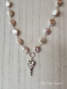 Coin pearls with the softest hint of blush hues, finished off with a silver heart pendant. Measures 16” Pearl Heart Necklace, Emerald Coast, Pearl Heart, Coin Pearls, Silver Heart Pendant, Silver Heart, Heart Necklace, Heart Pendant, Coin