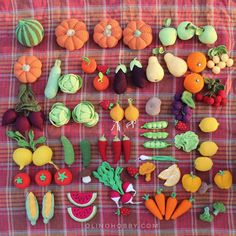 there are many different fruits and vegetables on this table cloth, including carrots, radishes, squash, cucumbers, watermelon, broccoli