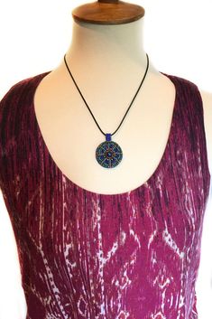 You'll fall in love with this beautifully handcrafted mandala pendant necklace with matching ring set. With its vibrant colors and intricately beaded design, this pendant stands out to make a unique, one-of-a-kind statement necklace wherever you wear it. The rich colors of turquoise green tiny glass seed beads and the exotic colbolt blue pop against the warmth of the bronze center glass cabochon and surround faceted fire polish beads in this kaleidoscope design. The word 'Mandala' means circle i Multicolor Medallion Necklace Spiritual Style, Adjustable Multicolor Round Pendant Jewelry, Multicolor Medallion Pendant Jewelry, Multicolor Medallion Beaded Necklace Gift, Spiritual Multicolor Round Pendant Necklace, Multicolor Medallion Beaded Necklace As Gift, Multicolor Medallion Beaded Necklace For Gift, Spiritual Beaded Round Pendant Jewelry, Multicolor Bohemian Medallion Beaded Necklaces