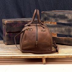 "DIMENSIONS: 10.5\"H x 19\"L x 10.5\"D x | 26.5 cm H x 48 cm L x 26.5 cm D CAPACITY : 34 L The Vintage Leather Duffel Bag For Men is the ultimate rebirth of antique style leather bag. We designed it with high quality top grain leather from cowhide. The vintage travel bag is designed to keep all your essentials centralized for a weekend. This leather duffle bag lets you work on-the-go with its extra laptop pocket made from a special cushion protection to keep your MacBook/laptop safe. We made sur Leather-backed Satchel Bag For Trips, Vintage Brown Bag With Zipper For Daily Use, Vintage Brown Bags With Zipper Closure For Daily Use, Brown Satchel Duffle Bag With Zipper Closure, Soft Leather Satchel For Overnight Trips, Brown Shoulder Bag For Overnight Trips, Leather Lined Tote Bag For Overnight Trips, Vintage Brown Bag With Zipper For Everyday Use, Brown Bag For Overnight Trips