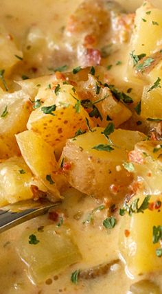 a close up of food on a spoon in a bowl with broccoli and potatoes